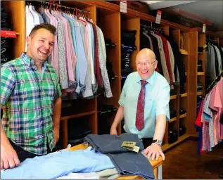  ??  ?? Conor Lynch and Joe Arrowsmith working in Micheal Lynch’s Menswear Shop on Clanbrassi­l Street.