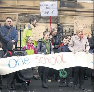  ??  ?? Protesters unfurled signs protesting at the decision to remove their school jannie