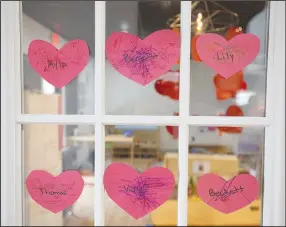  ?? (NWA Democrat-Gazette/J.T. Wampler) ?? Hearts for Valentine’s Day adorn a window at Kirsty’s Place Child Care in Fayettevil­le on Friday. Visit nwaonline.com/photo for today’s photo gallery.