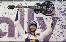  ?? MARK HUMPHREY – THE ASSOCIATED PRESS ?? Chase Elliott holds the guitar presented to him after winning Sunday's NASCAR Cup Series race at Nashville Superspeed­way.
