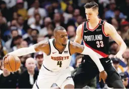  ?? (AFP) ?? Paul Millsap (left) of the Denver Nuggets makes his move against Zach Collins of the Portland Trail Blazers during NBA playoff action at the Pepsi Center in Denver, Colorado. The Nuggets won, 124-98.