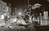  ?? Jun Hirata / Associated Press ?? A structure falls in Koorimachi early Sunday after a major earthquake struck off northeaste­rn Japan.