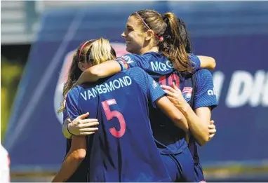  ?? K.C. ALFRED U-T ?? Alex Morgan of the Wave FC (center) celebrates a goal with Emily van Egmond (5) and teammates on Sunday.