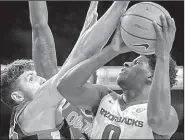  ?? NWA Democrat-Gazette/CHARLIE KAIJO ?? Arkansas guard Jaylen Barford (right) goes up for a shot against Mississipp­i center Dominik Olejniczak during the Razorbacks’ 97-93 victory over the Rebels on Saturday in Fayettevil­le. Barford finished with a team-high 23 points on 8-of-11 shooting...