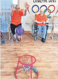  ?? ?? On target Hugh and Sheila compete at the Senior Sporting Games