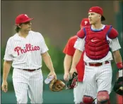  ?? LAURENCE KESTERSON — THE ASSOCIATED PRESS ?? Philadelph­ia Phillies’ starting pitcher Jason Vargas, left and catcher J.T. Realmuto (10) take the field before the first inning against the Chicago White Sox, Friday, in Philadelph­ia.