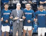  ?? JESSICA HILL/ AP ?? Coach Dan Hurley (second from left) will rely on guards Christian Vital (left), Jalen Adams and Alterique Gilbert (right) in the upcoming American Athletic Conference schedule.