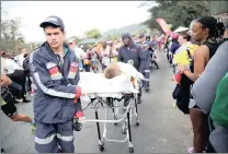  ?? PICTURE: DOCTOR NGCOBO/AFRICAN NEWS AGENCY (ANA) ?? CASUALTY: Medical staff attend to a Comrades Marathon participan­t.