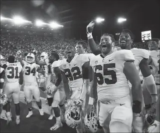  ?? ASSOCIATED PRESS ?? near fans at Autzen Stadium after defeating Oregon 38-31 in overtime Saturday in