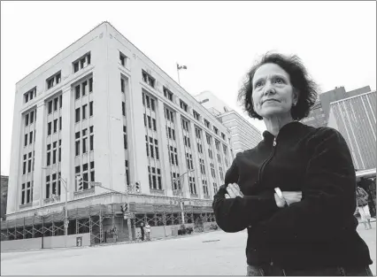  ?? TYLER BROWNBRIDG­E/THE Windsor Star ?? Joan Shanfield stands Friday across the street from the Paul Martin federal building. Shanfield said the scaffoldin­g
that has lined the sides of the landmark 1933 building for years is “a fiasco, it’s an eyesore, it’s ugly.”