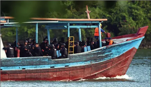  ??  ?? Deadly mission: A ramshackle boat carrying the 12-man Indonesian firing squad makes its way to ‘Execution Island’ yesterday