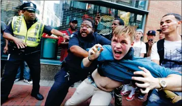  ?? ASSOCIATED PRESS ?? A COUNTERPRO­TESTER, PART OF A SMALL GROUP who remained on the street hours after a “Free Speech” rally was staged by conservati­ve activists, scuffles with a security guard and police Saturday in Boston.