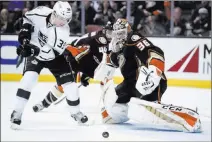  ?? KELVIN KUO USA TODAY ?? Ducks goaltender John Gibson makes a save in front of Kings left wing Adrian Kempe in the third period of Anaheim’s 1-0 victory Sunday at the Honda Center. Gibson stopped 24 shots.