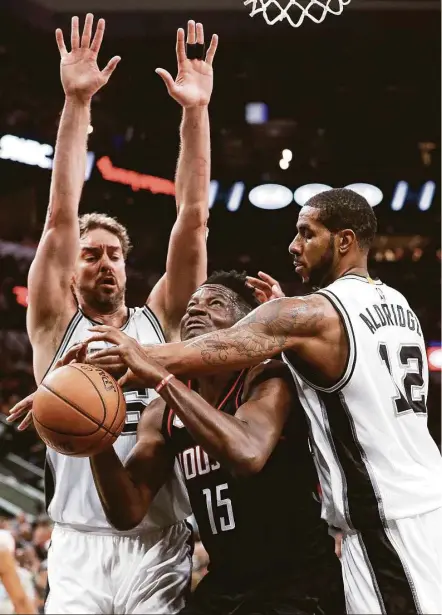  ?? Karen Warren / Houston Chronicle ?? The Rockets’ Clint Capela, center, gets double-teamed by Spurs center Pau Gasol, left, and forward LaMarcus Aldridge in the second half of Game 2. Capela was 6-for-8 for 14 points, but the Spurs were more effective against James Harden (3-for-17).