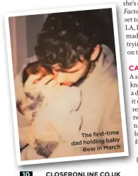  ??  ?? The first-time holding baby dad Bear in March