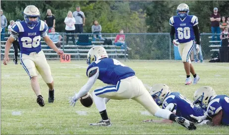  ?? Westside Eagle Observer/MIKE ECKELS ?? After a fumble, Bulldog running back Landon Watson (4) dives to recover the ball during the first quarter of the Decatur-Magazine homecoming football game in Decatur Friday night. Watson recovered the loose ball, allowing the Bulldogs to continue their march downfield.