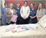  ??  ?? Left, Lisa Woodcock, Kerry Haywood, Lindsey Carver, Sam Iliffe, Jackie Davies and Debra Prosser in George Eliot Hospital’s maternity ward. and right Gareth and Sam Iliffe, holding daughter Poppy