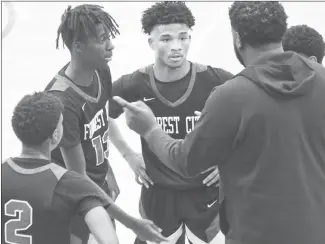  ?? Fred Conley • Times-Herald ?? Forrest City Mustang assistant coach Trey Thompson talks with players during a timeout at the Rumble on the Ridge tournament played last weekend. The Mustangs will host Marianna Lee tonight at Mustang Arena.