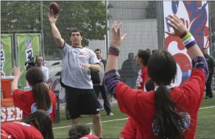  ?? MARY ALTAFFER — THE ASSOCIATED PRESS ?? In this 2012file photo, Andrew Luck, center left, throws the ball during the NFL Play 60Youth Football Festival in New York. When the NFL launched Play 60a decade ago as a way to get American youth active, the league had no idea what kind of reach the...