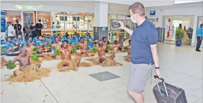  ?? Picture: REINAL CHAND ?? Plantation Island Resort employees perform a meke for guests arriving at the Nadi Internatio­nal Airport on the first flight from Sydney as Fiji opens its internatio­nal border for travel.