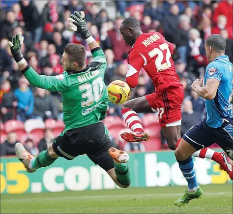  ?? PICTURES: Media Image Ltd ?? STAR TURN: Leeds’ Jack Butland saves from Albert Adomah while Lee Peltier looks on