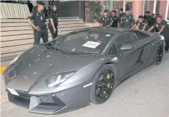  ??  ?? A luxury car belonging to Alexandre Cazes is brought to the Narcotics Suppressio­n Bureau. Authoritie­s succeeded in seizing assets worth 726 million baht from the suspect.