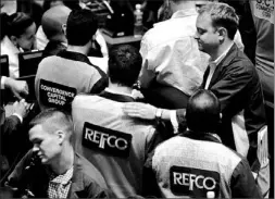  ?? SHANNON STAPLETON/REUTERS ?? A broker gives a Refco broker a pat on the back at the New York Mercantile Exchange yesterday. Refco filed for bankruptcy protection yesterday.