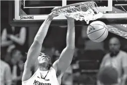  ?? Associated Press ?? Minnesota center Reggie Lynch dunks against Rutgers during the first half of an NCAA college basketball game Sunday in Minneapoli­s.