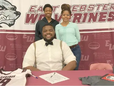  ?? (Photo by Robbie Faulk, SDN) ?? East Webster lineman Rashad Hamilton, seated, celebrates his signing with Mississipp­i Delta Community College on Wednesday morning.