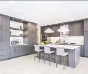  ??  ?? The kitchen in the West District home features integrated appliances and matte finish cabinetry made locally.