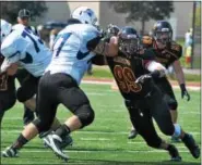  ?? BARRY TAGLIEBER - FOR THE PHOENIX ?? Ursinus defensive end Steve Ambs (99) battles Franklin & Marshall offensive tackle Ryan Ignatovig (77) during a Centennial Conference football game earlier this season.