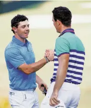  ?? Sam Greenwood / Getty Images ?? Rory McIlroy (left) caught Billy Horschel on the leaderboar­d and then for a post-round handshake.