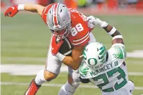  ?? JAY LAPRETE/ASSOCIATED PRESS ?? Oregon defensive back Verone McKinley, right, tackles Ohio State tight end Jeremy Ruckert during the second half of Saturday’s game in Columbus, Ohio. Oregon beat Ohio State 35-28.