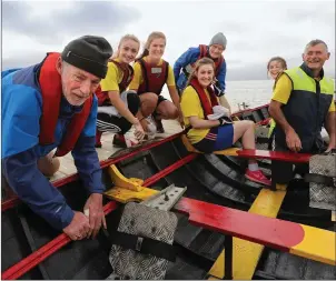 ??  ?? Members of Callinafer­cy Rowing Club getting their boat ready for the day’s rowing. Larry Laide, Aisling Scanlon, Katie Boyle, Orla Murphy, JJ O’Sullivan, Aoife Murphy, Mickie Scanlon.