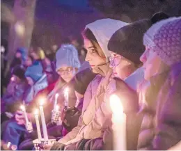  ?? SCOTT ASH/MILWAUKEE JOURNAL-SENTINEL ?? People gather for a candleligh­t vigil Monday for those affected by Sunday’s parade tragedy in Waukesha, which is 20 miles west of Milwaukee.