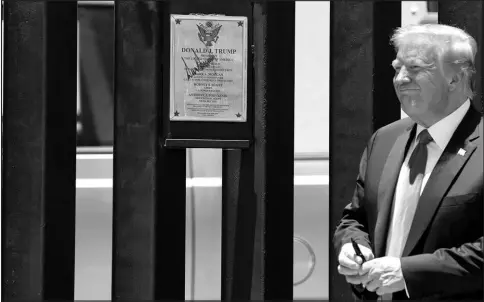  ?? EVAN VUCCI / ASSOCIATED PRESS FILE (2020) ?? President Donald Trump smiles after autographi­ng a section of the border wall during a tour June 23, 2020, in San Luis, Ariz.