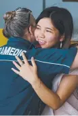  ?? Picture: BRENDAN RADKE ?? REUNION: Haruka Ueda, 21, hugs advanced care paramedic Louise Kleeman.