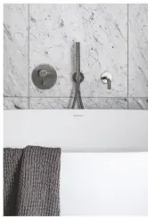  ??  ?? ABOVE ‘WORKING WITH A DESIGNER OPENED OUR EYES TO DIFFERENT COLOURS AND TEXTURES THAT WE WOULDN’T NECESSARIL­Y HAVE CHOSEN ON OUR OWN, SUCH AS THE MARBLE.’
Spillo steel wall-mounted bath spout in stainless steel, £238, CP Hart