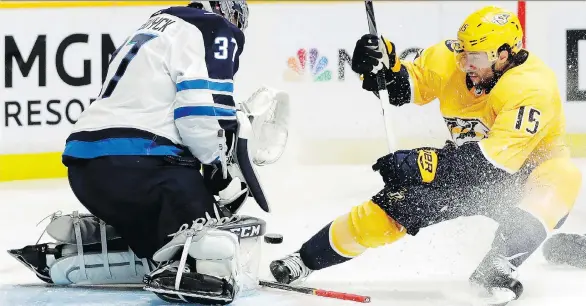  ?? MARK HUMPHREY/THE ASSOCIATED PRESS ?? Winnipeg goalie Connor Hellebuyck was a wall in net Friday, stopping Craig Smith and almost every other Nashville player in a 4-1 Jets victory.