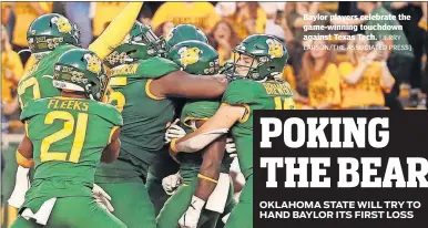  ?? [JERRY LARSON/THE ASSOCIATED PRESS] ?? Baylor players celebrate the game-winning touchdown against Texas Tech.