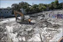  ?? DEBORAH CANNON / AMERICAN-STATESMAN ?? Constructi­on continues Friday in the 1100 block of South Congress Avenue, the former site of Doc’s Motorworks Bar & Grill and several other businesses. The mixed-use project going up also will take land held by Twomey’s Auto Works.