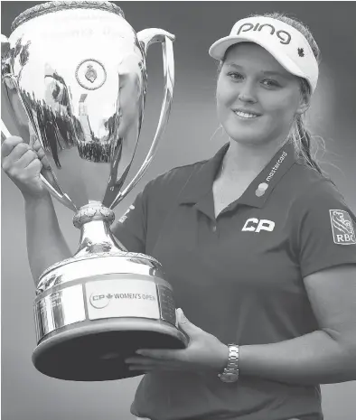  ?? TROY FLEECE / POSTMEDIA NEWS ?? Brooke Henderson of Smiths Falls, Ont., hoisted the championsh­ip trophy in August at the Wascana Country Club in Regina after becoming the first homegrown Canadian since 1973 to capture the LPGA CP Women’s Open. Henderson is this year’s Postmedia Female Athlete of the Year for the third time in four years.