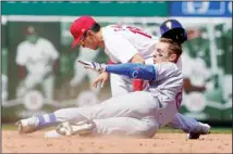  ?? ?? New York Mets’ Mark Canha, front, is tagged out by St. Louis Cardinals second baseman Tommy Edman while trying to stretch a single into a double during the sixth inning of a baseball game, on April 27, in St. Louis. (AP)