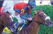  ?? Rob Carr Getty Images ?? SWISS SKYDIVER and jockey Robby Albarado win the Preakness Stakes after a duel with Authentic.