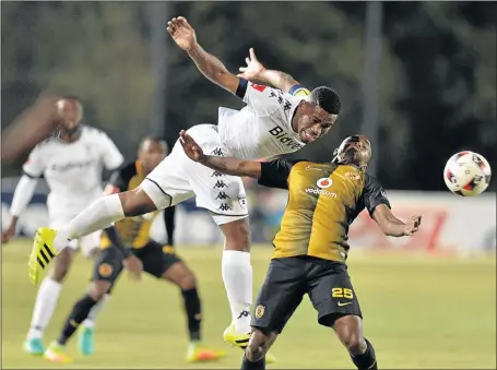  ?? PHOTO: LEFTY SHIVAMBU/GALLO IMAGES ?? Wits’ Thulani Hlatshwayo wins one of the many aerial battles that gave little room for Bernard Parker and his Chiefs teammates in their Absa Premiershi­p game last night.
