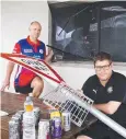  ?? Picture: ANNA ROGERS ?? DAMAGE: Mulgrave Cricket canteen supervisor Robbie Douglas and Southside Comets president Keiren O'Brien at the window vandalised using a street sign.