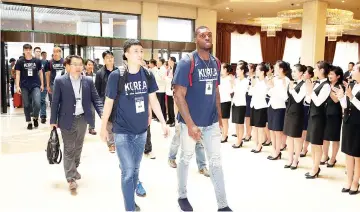  ??  ?? Members of South Korean men’s basketball team are greeted by employees upon their arrival at Koryo hotel in Pyongyang, North Korea.