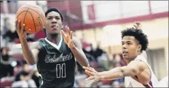  ?? Hans Pennink / Special to the Times Union ?? Schalmont senior LJ Randle (11) scores in front of Watervliet’s Khari Croley during the first half on Dec. 18 in Watervliet. Randle averages 15.8 points per game for the Sabres, ranked No. 2 in the state in Class B.