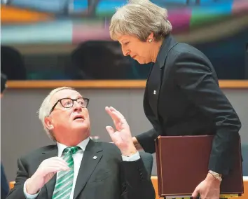  ?? Bloomberg ?? Jean-Claude Juncker, president of the European Commission, speaks with May during a round-table discussion at a European Union leaders summit in Brussels yesterday.