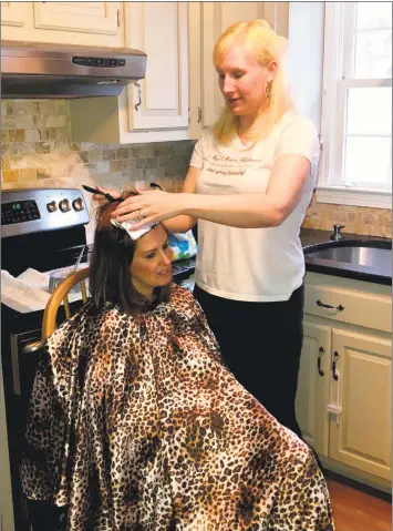  ?? Deborah Rose / Hearst Connecticu­t Media ?? Meg Shaw, of Gaylordsvi­lle, with client Halie Detray, of Brookfield. Shaw owns Meg’s Mobile Hairdressi­ng & Spray Tanning.